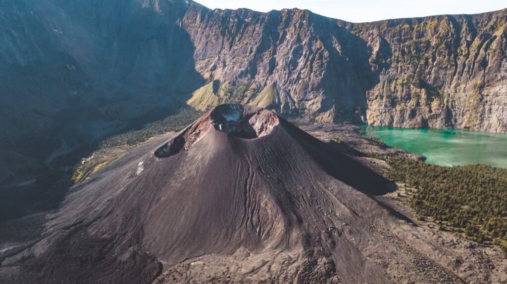 Stunning aerial shot of Mount Rinjani's crater in Lombok with vibrant turquoise lake.